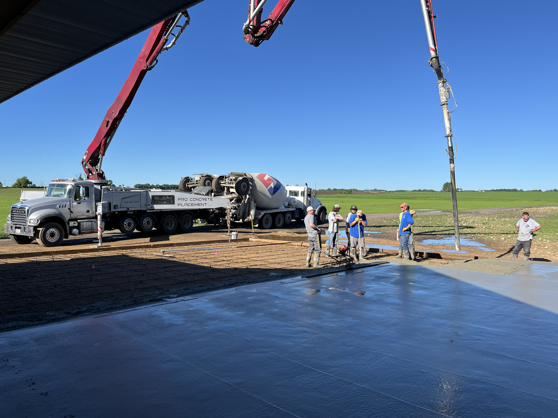 Concrete boom pump serving a large flatwork pour